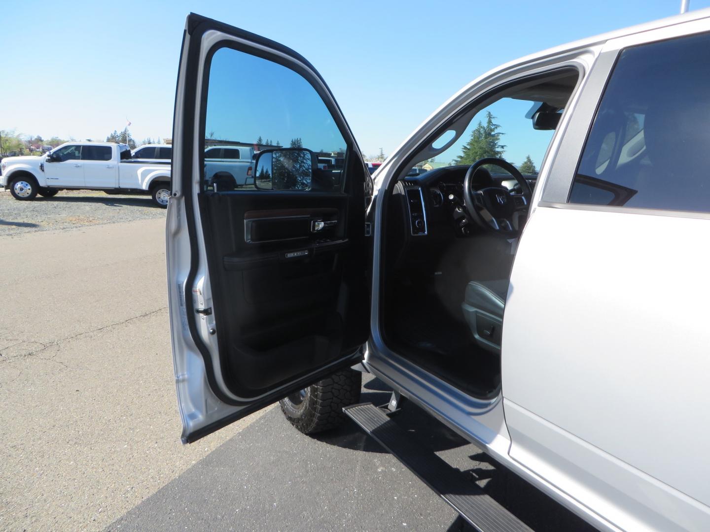 2016 SILVER /BLACK RAM 2500 Laramie Crew Cab SWB 4WD (3C6UR5FL3GG) with an 6.7L L6 OHV 24V TURBO DIESEL engine, 6A transmission, located at 2630 Grass Valley Highway, Auburn, CA, 95603, (530) 508-5100, 38.937893, -121.095482 - Leveled Ram sitting on Fuel Offroad wheels, Falken Wildpeak AT tires, Amp Power steps, Rolling Bed cover, Color matched fender flares, and window tint. - Photo#13